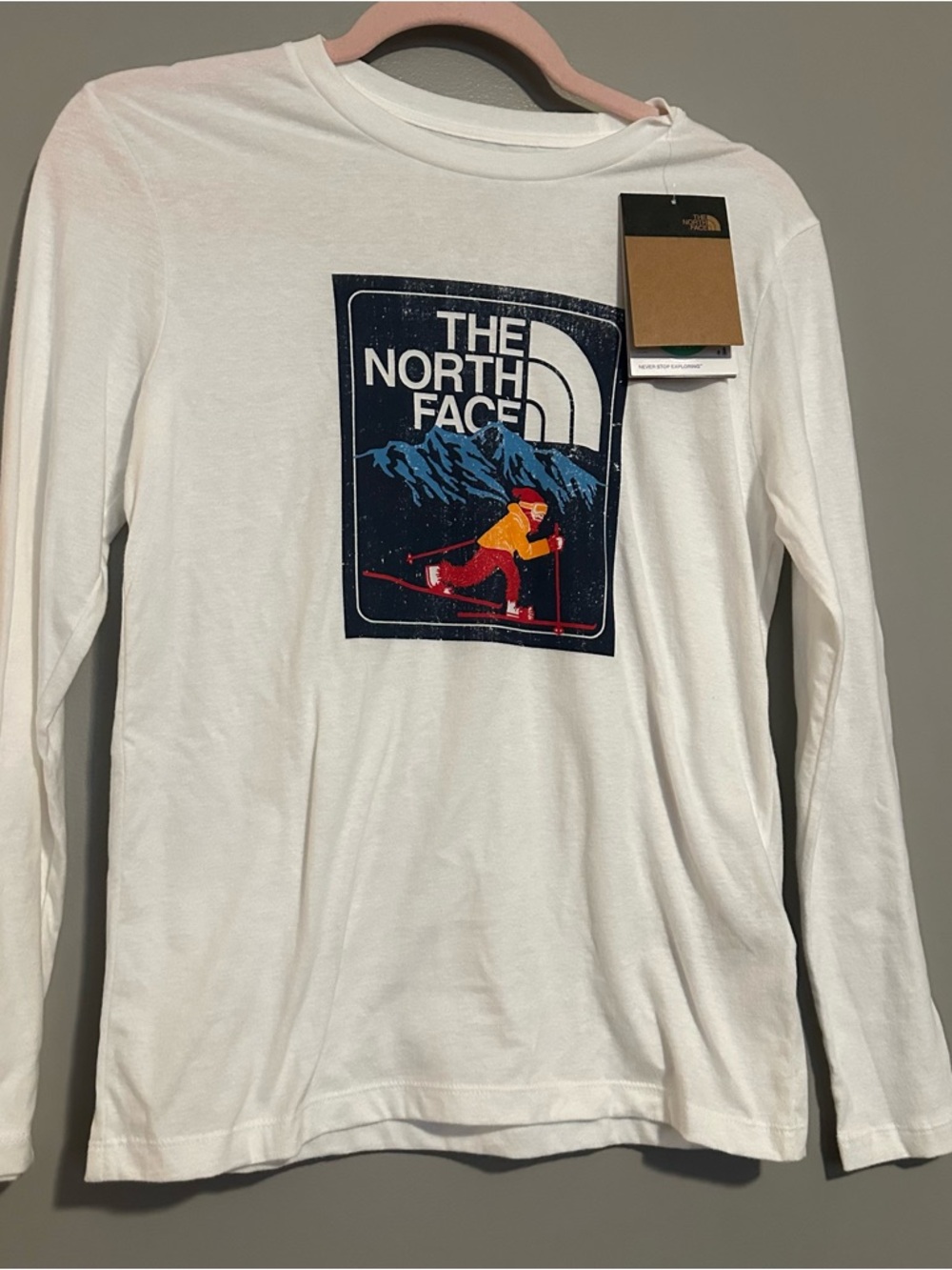 The North Face White Ski Graphic Long Sleeve Tee with Red & Yellow Accents
